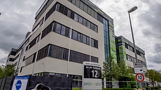 FILE - In this May 6, 2021 file photo a man with a face mask leaves the headquarters of the German biotechnology company "BioNTech" in Mainz, Germany.