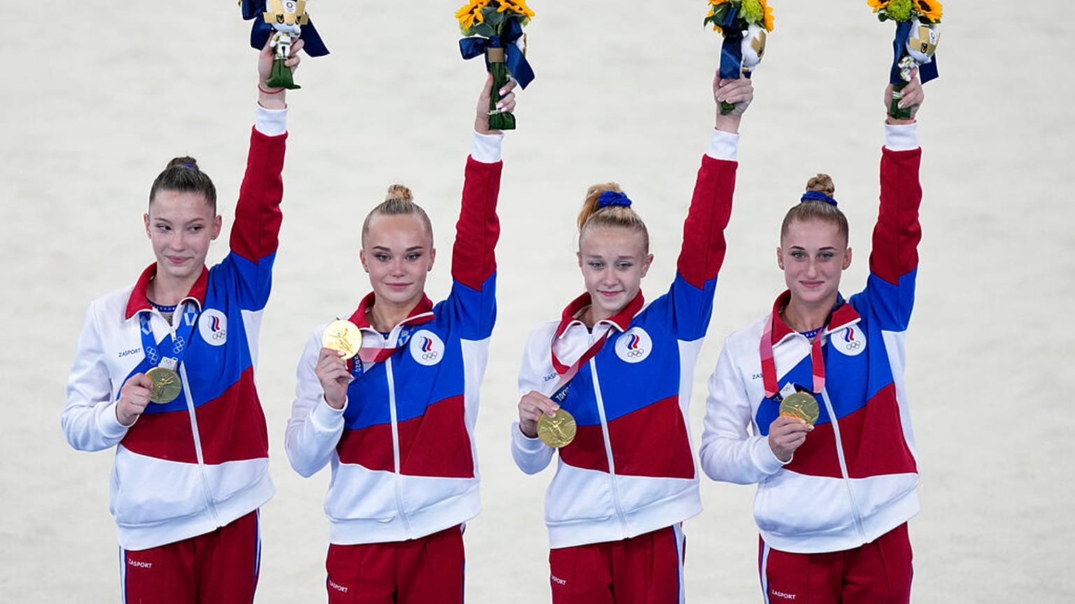 Russian Olympic Committee's artistic gymnastics women's team, from right, Liliia Akhaimova, Viktoriia Listunova, Angelina Melnikova and Vladislava Urazova celebrate.