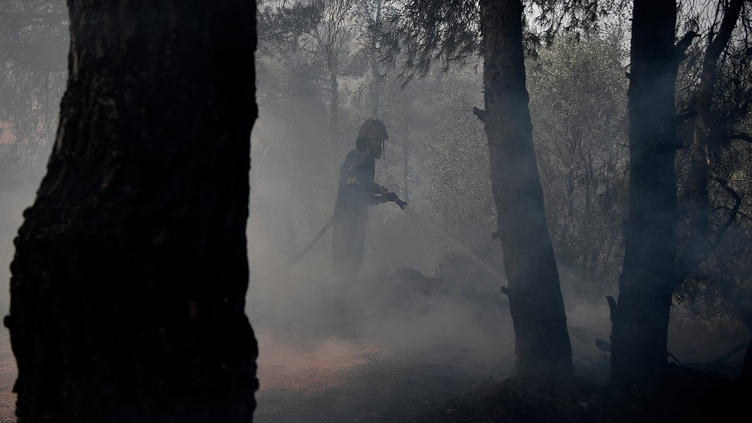 Firefighters battle a wildfire in Dionysos, north east of Athens, on July 27, 2021.