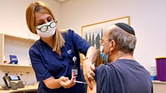 A man receives a third dose of the Pfizer-BioNTech COVID-19 coronavirus vaccine