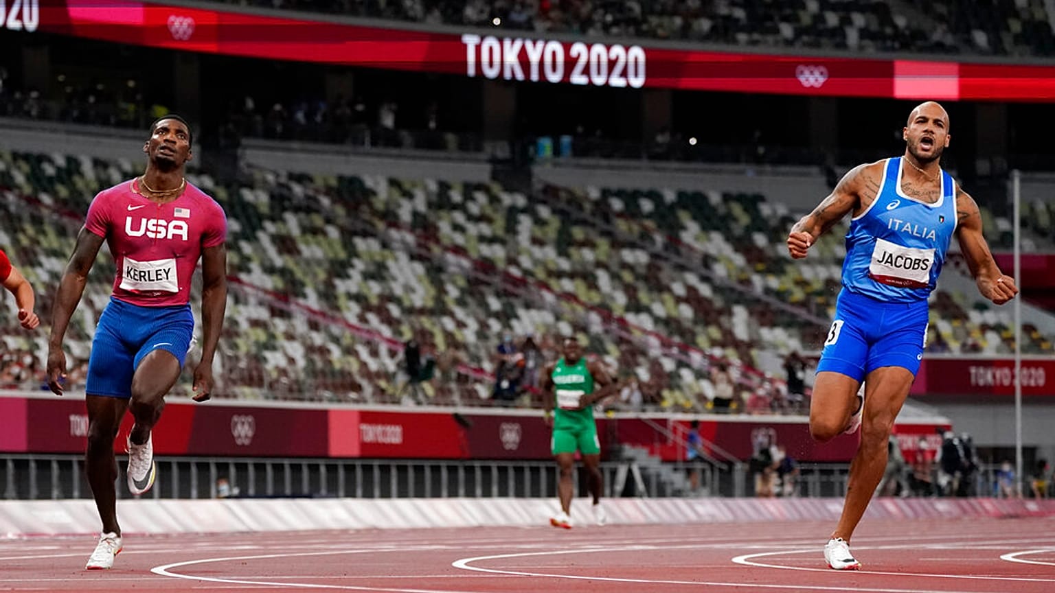 Lamont Jacobs, right, of Italy, celebrates after winning the men's the 100-meter final at the 2020 Summer Olympics, Sunday, Aug. 1, 2021, in Tokyo.
