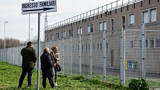 Inmates' relative stand outside the Sant’Anna prison in Modena, Emilia-Romagna, in one of Italy's quarantine red zones on March 9, 2020.