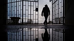 In this Sunday, Jan. 27, 2019 file photo a man walks through the gate of the Sachsenhausen Nazi death camp with the phrase 'Arbeit macht frei' (work sets you free)
