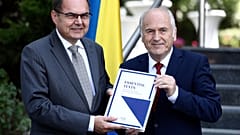 Christian Schmidt, new head of Bosnia's Office of the High Representative or OHR (L) with Valentin Inzko, during a ceremony Sarajevo, Bosnia, Aug. 2, 2021.