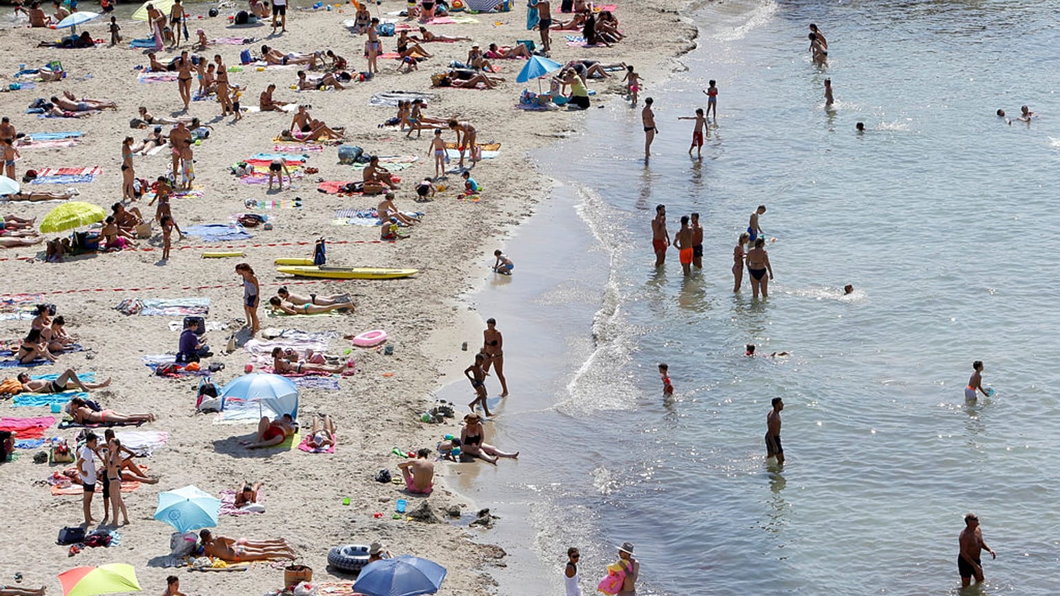 People sunbath in the Mediterranean sea at the Prophete beach, in Marseille