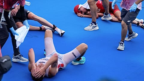 The gold, silver and bronze medal winners of the men's triathlon event collapsed after crossing the finish line in Tokyo