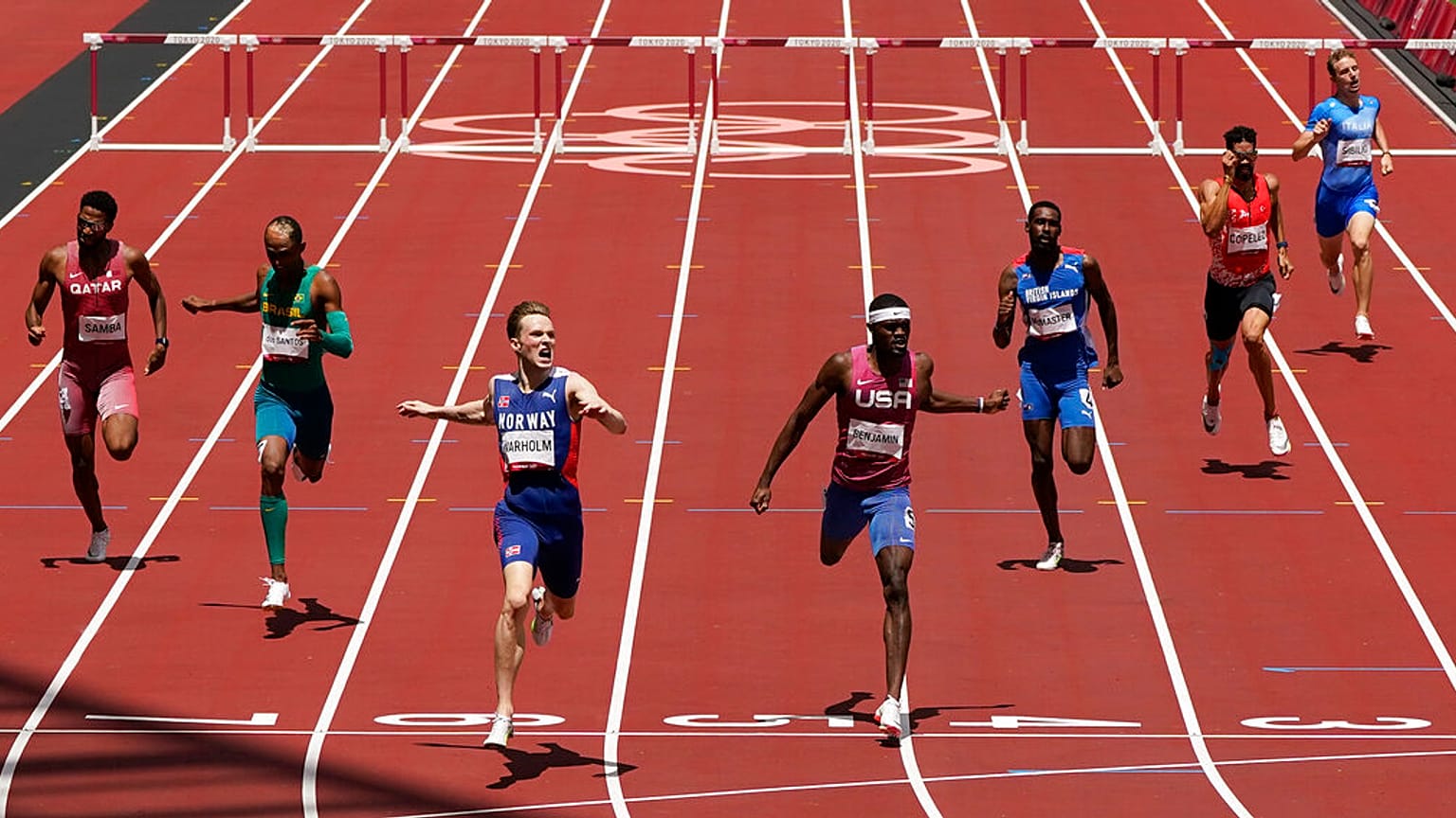 Karsten Warholm, of Norway, third left, celebrates as he wins the gold medal ahead of Rai Benjamin, of United States in the final of the men's 400-meter hurdles 