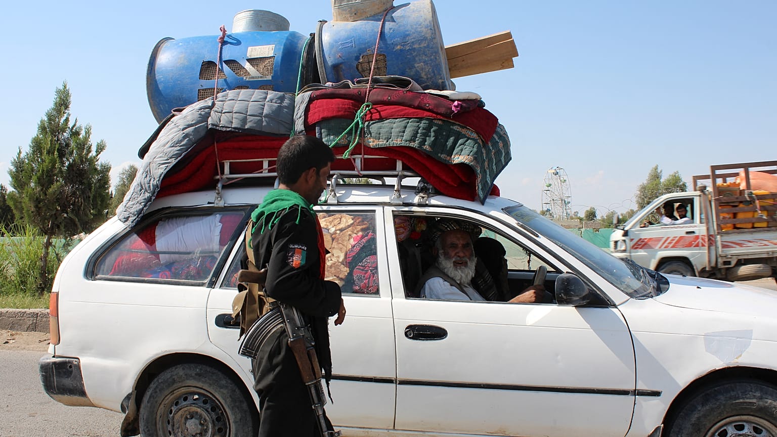 An internally displaced family flees ongoing fighting between Afghan security forces and Taliban fighters, on the outskirts of Lashkar Gah.