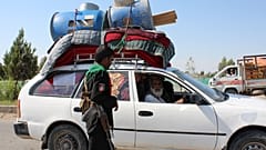 An internally displaced family flees ongoing fighting between Afghan security forces and Taliban fighters, on the outskirts of Lashkar Gah.