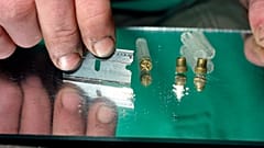 A razor blade is used to divide the contents of a vile of crack, a smokable, purified form of cocaine, at a crack house in the South Bronx, New York, in 1989.