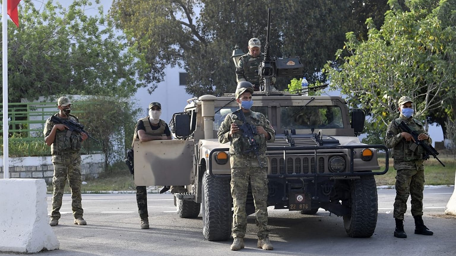 Tunisian soldiers cordon-off the Parliament in the capital Tunis, following a move by the president to suspend the country's parliament and dismiss the Prime Minister.
