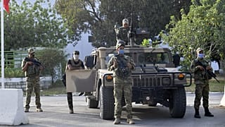 Tunisian soldiers cordon-off the Parliament in the capital Tunis, following a move by the president to suspend the country's parliament and dismiss the Prime Minister.