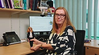 Professor Sarah Gilbert holding her new Barbie doll.