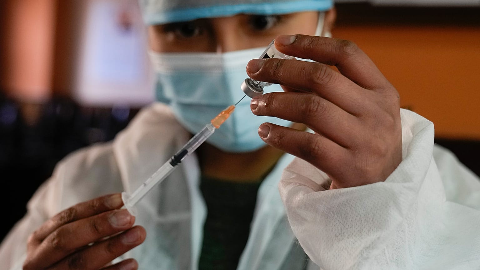 A health worker prepares a shot of the Johnson & Johnson COVID-19 vaccine  in La Paz, Bolivia, Aug. 3, 2021. 