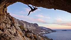 A climber scales a cliff face