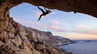 A climber scales a cliff face