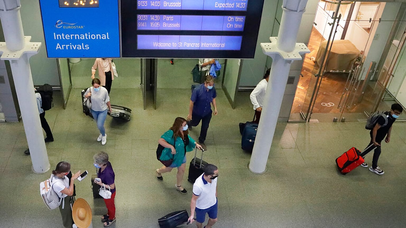 Travellers arrive from a Eurostar train at St Pancras Station in London, Friday, Aug. 14, 2020.