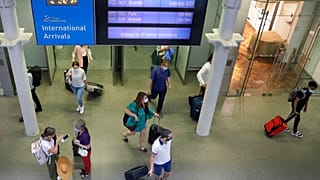 Travellers arrive from a Eurostar train at St Pancras Station in London, Friday, Aug. 14, 2020.
