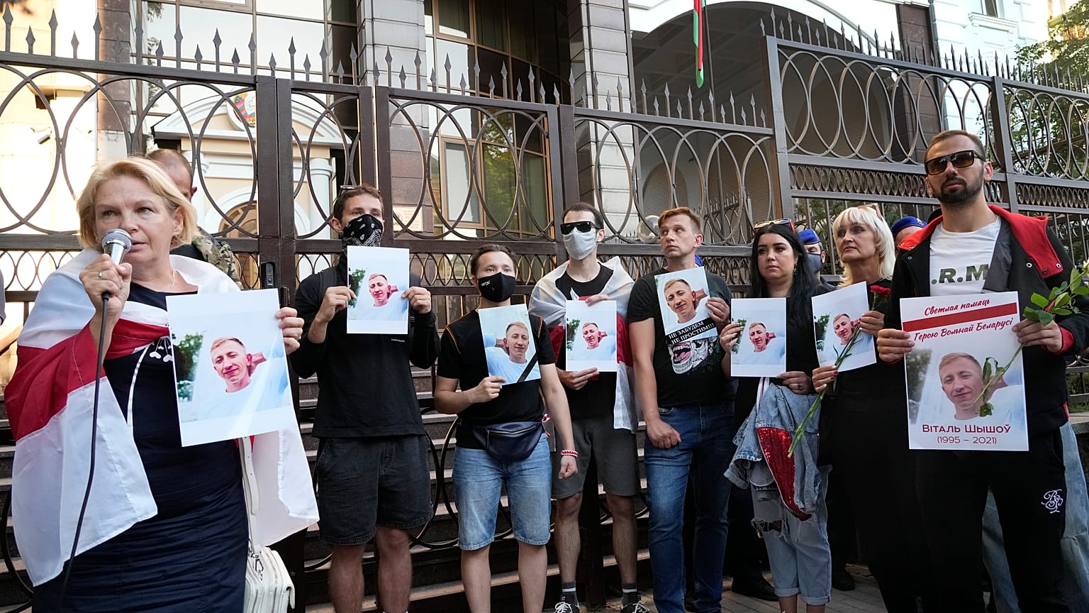 Activists hold portraits of activist Vitaly Shishov, leader of the Belarusian House in Ukraine, during a rally in front of the Belarus Embassy in Kyiv, August 3, 2021. 