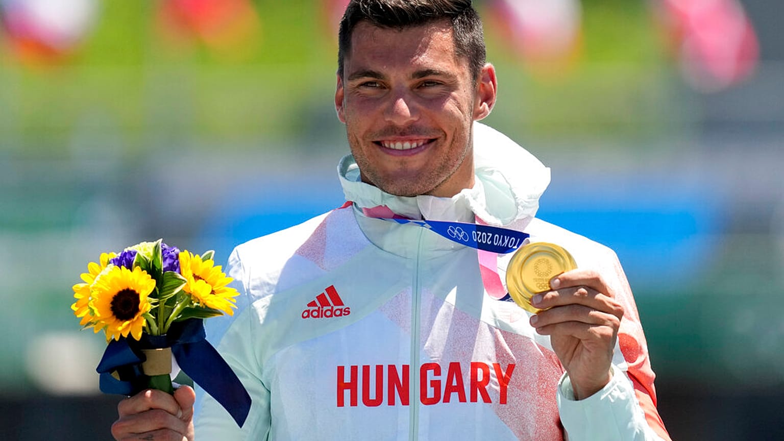 Sandor Totka, of Hungary, holds up his gold medal in the men's kayak single 200m final at the 2020 Summer Olympics