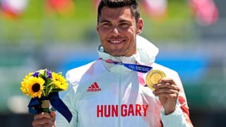 Sandor Totka, of Hungary, holds up his gold medal in the men's kayak single 200m final at the 2020 Summer Olympics