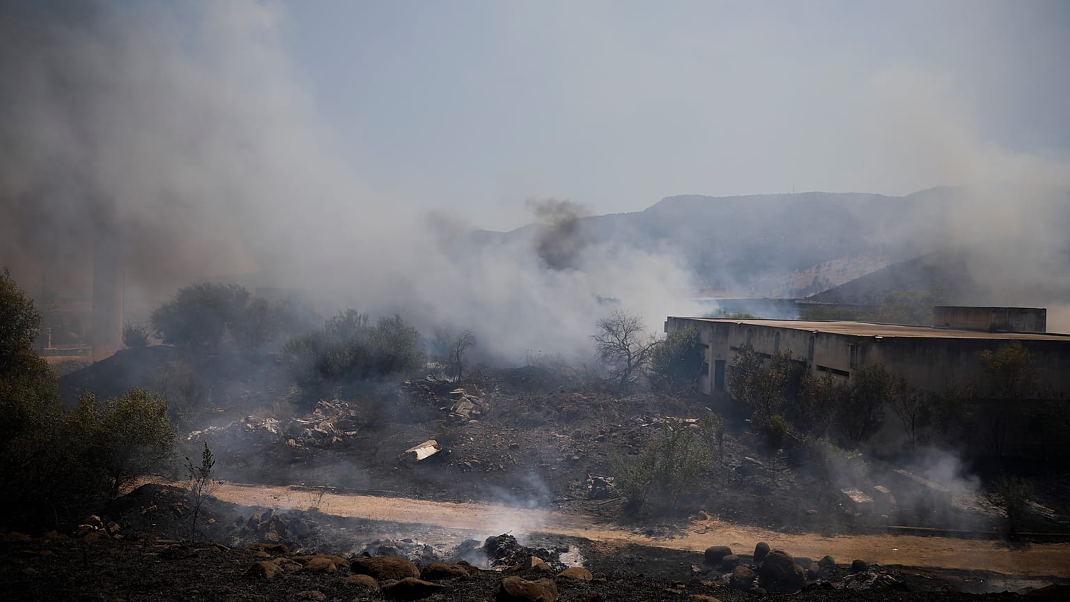 Fields burn following a hit by a rocket fired from Lebanon into Israeli territory, near the northern Israeli town of Kiryat Shmona, Wednesday, Aug. 4, 2021. 