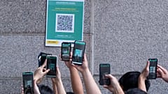 Visitors scan a QR code for the Hong Kong government's "Leave Home Safe" app to trace people in the advent of any Covid-19 outbreaks