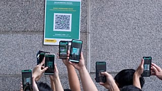 Visitors scan a QR code for the Hong Kong government's "Leave Home Safe" app to trace people in the advent of any Covid-19 outbreaks