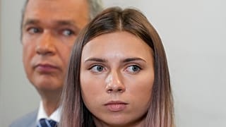 Exiled Belarusian Olympic sprinter Krystsina Tsimanouskaya, right, speaks to reporters in Warsaw on Wednesday accompanied by dissident former minister Pavel Latushka