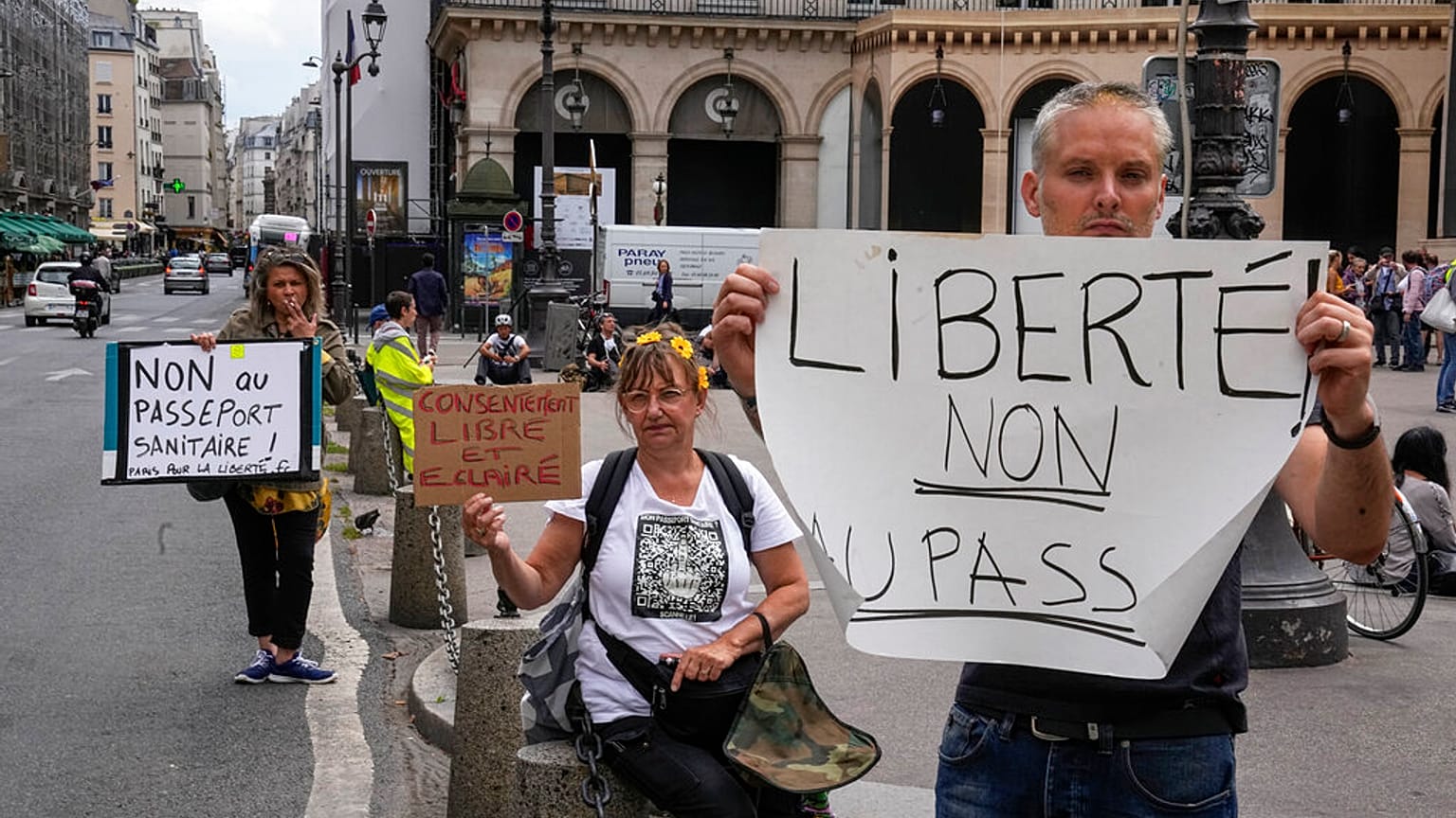 Anti heath pass demonstrators hold placards that read, liberty no to the health pass, outside the Constitutional Council in Paris, Thursday, Aug. 5,2021