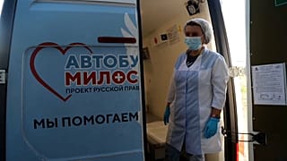 Health worker waiting at back of mobile vaccination unit