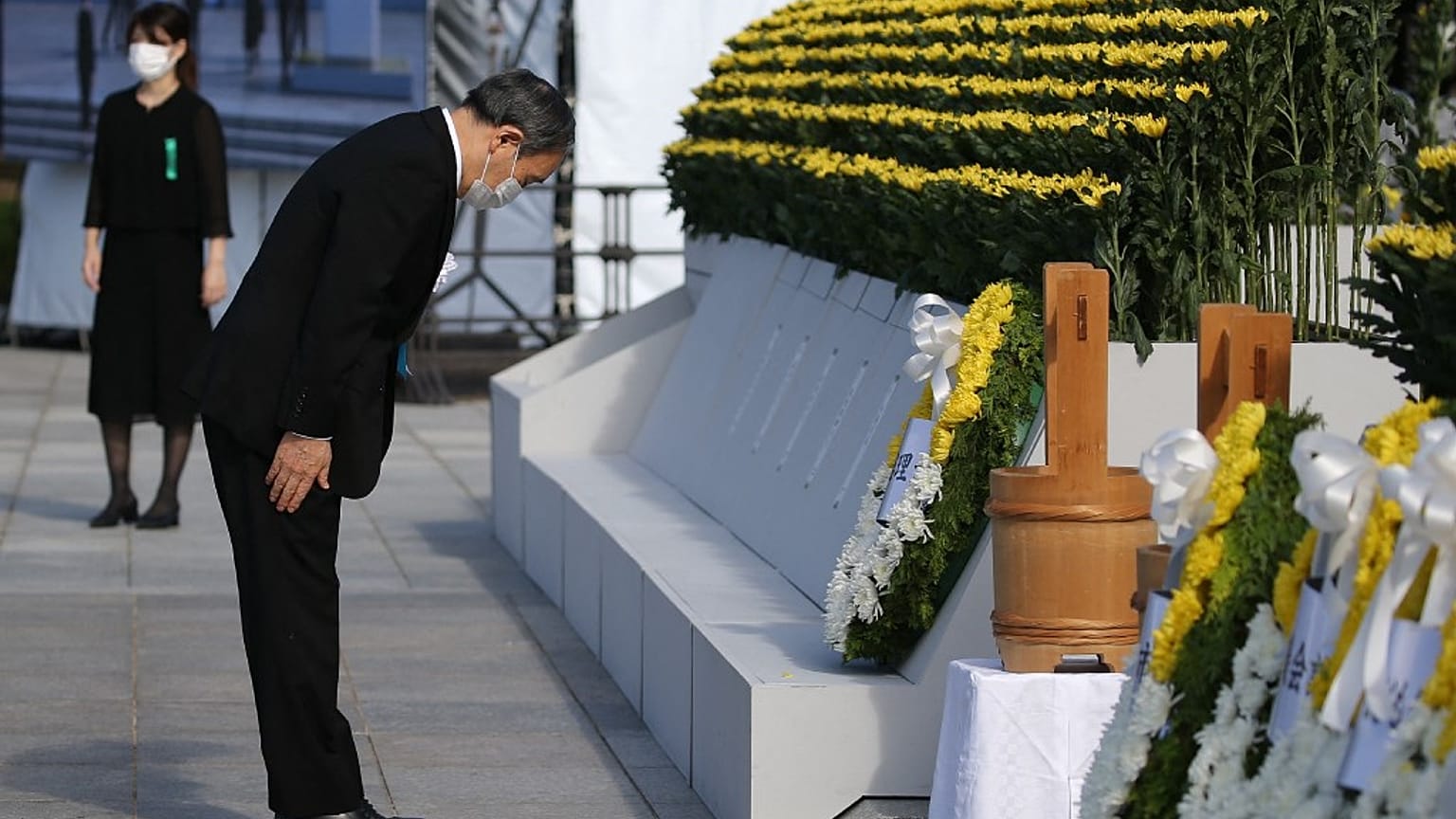 Japan's Prime Minister Yoshihide Suga pays his respects during a ceremony to mark the 76th anniversary of the Hiroshima atomic bomb attack.