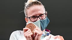 Sarolta Kovacs of Hungary celebrates on the podium with the bronze medal she won in women's modern pentathlon