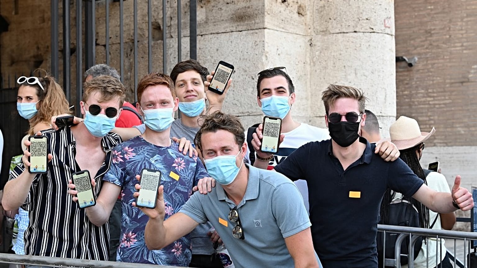 Visitors show their Covid-19 certificates before entering the Ancient Colosseum in Rome on August 6, 2021, as Italy made the Green Pass compulsory. 