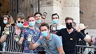 Visitors show their Covid-19 certificates before entering the Ancient Colosseum in Rome on August 6, 2021, as Italy made the Green Pass compulsory.