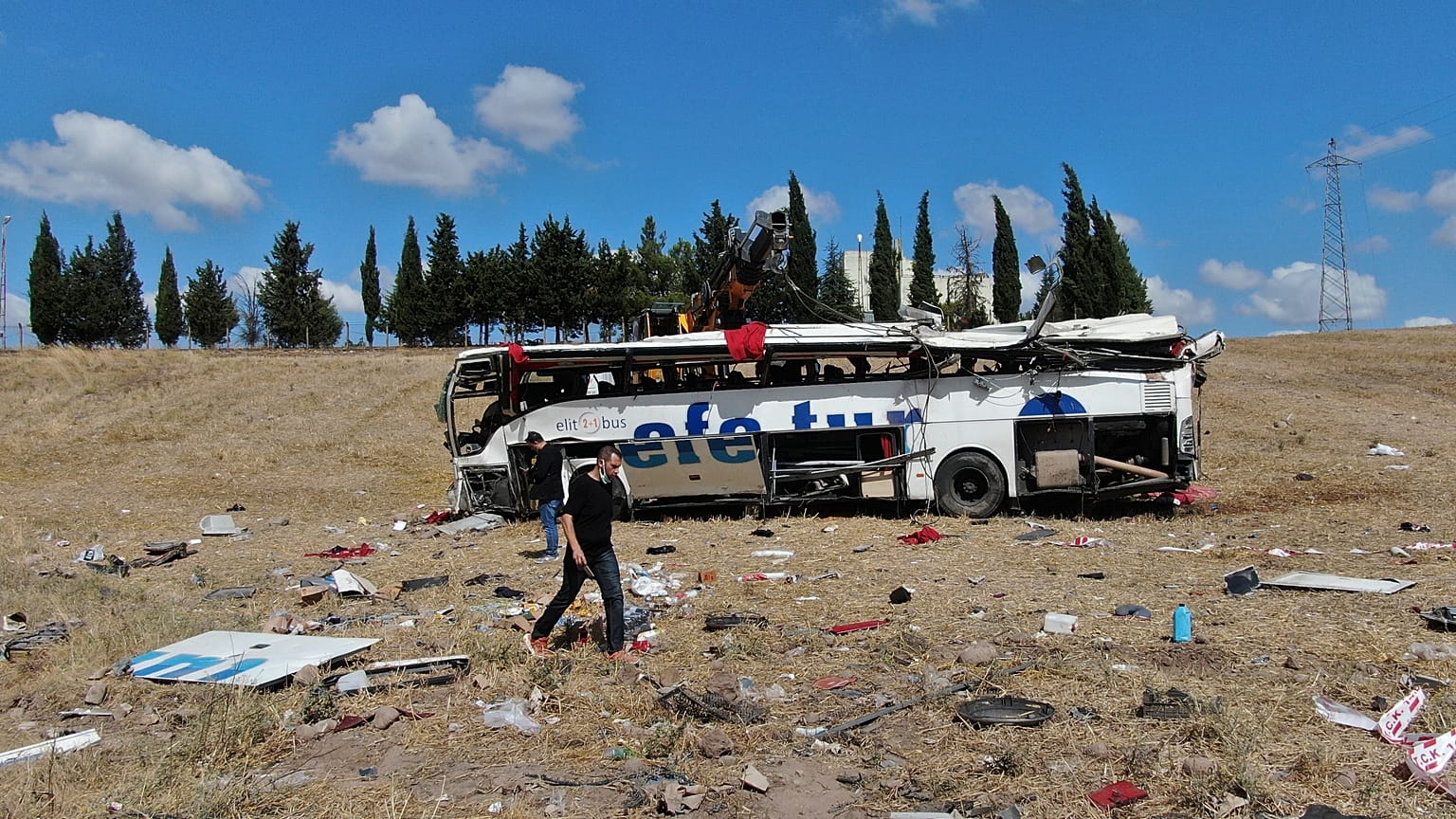 Officials investigate at the site of a bus crash, in Balikesir, western Turkey, Aug. 8, 2021. 