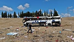 Officials investigate at the site of a bus crash, in Balikesir, western Turkey, Aug. 8, 2021. 
