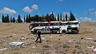 Officials investigate at the site of a bus crash, in Balikesir, western Turkey, Aug. 8, 2021. 