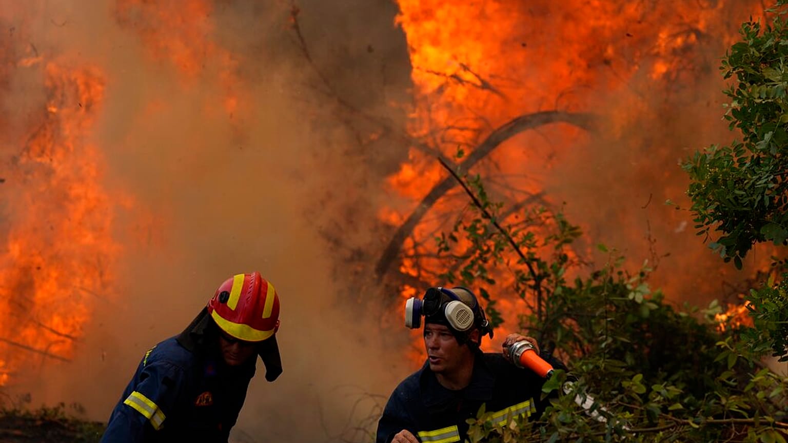 Firefighters operate at Ellinika village on Evia island, about 176 kilometers (110 miles) north of Athens, Greece, Monday, Aug. 9, 2021