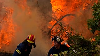 Firefighters operate at Ellinika village on Evia island, about 176 kilometers (110 miles) north of Athens, Greece, Monday, Aug. 9, 2021