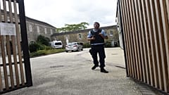 A French gendarme stands at the entrance of the place where a French catholic priest, aged 60, has been murdered in Saint-Laurent-sur-Sevres, Western France, on August 9, 2021