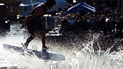 A wakeboarder takes off against the light during a wakeboard event organised by a drinks company in Hamburg, Germany