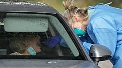 A woman receives a COVID-19 test at a testing station in Australia, Monday, June 28, 2021. 