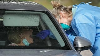 A woman receives a COVID-19 test at a testing station in Australia, Monday, June 28, 2021. 