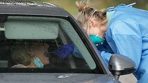 A woman receives a COVID-19 test at a testing station in Australia, Monday, June 28, 2021. 