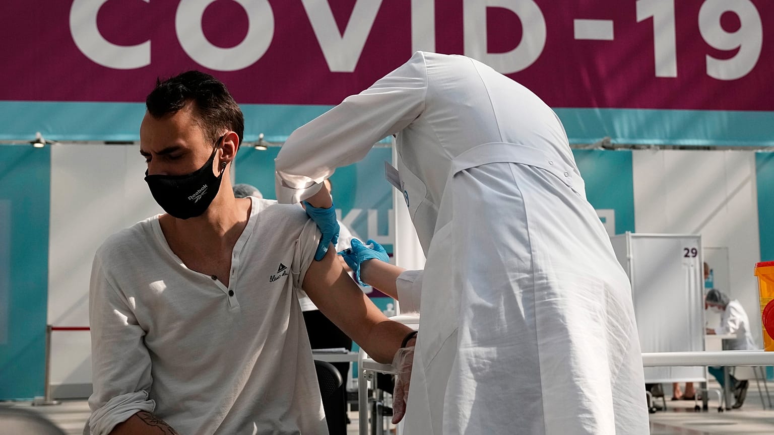 A medical worker administers a shot of Russia's Sputnik V coronavirus vaccine at a Moscow vaccination centre on  July 12, 2021.