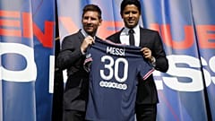 Lionel Messi poses with Paris St Germain president Nasser Al-Khelaifi at his unveiling.
