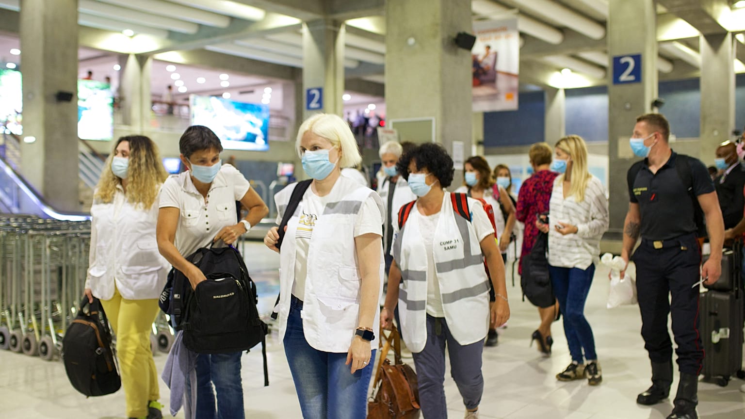 Emergency Medical Service staff arrive to airport in Pointe-à-Pitre to help Guadeloupe stretched medical teams