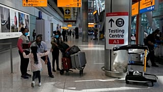 Travellers walk towards the Covid-19 testing centre at Heathrow Airport in London.