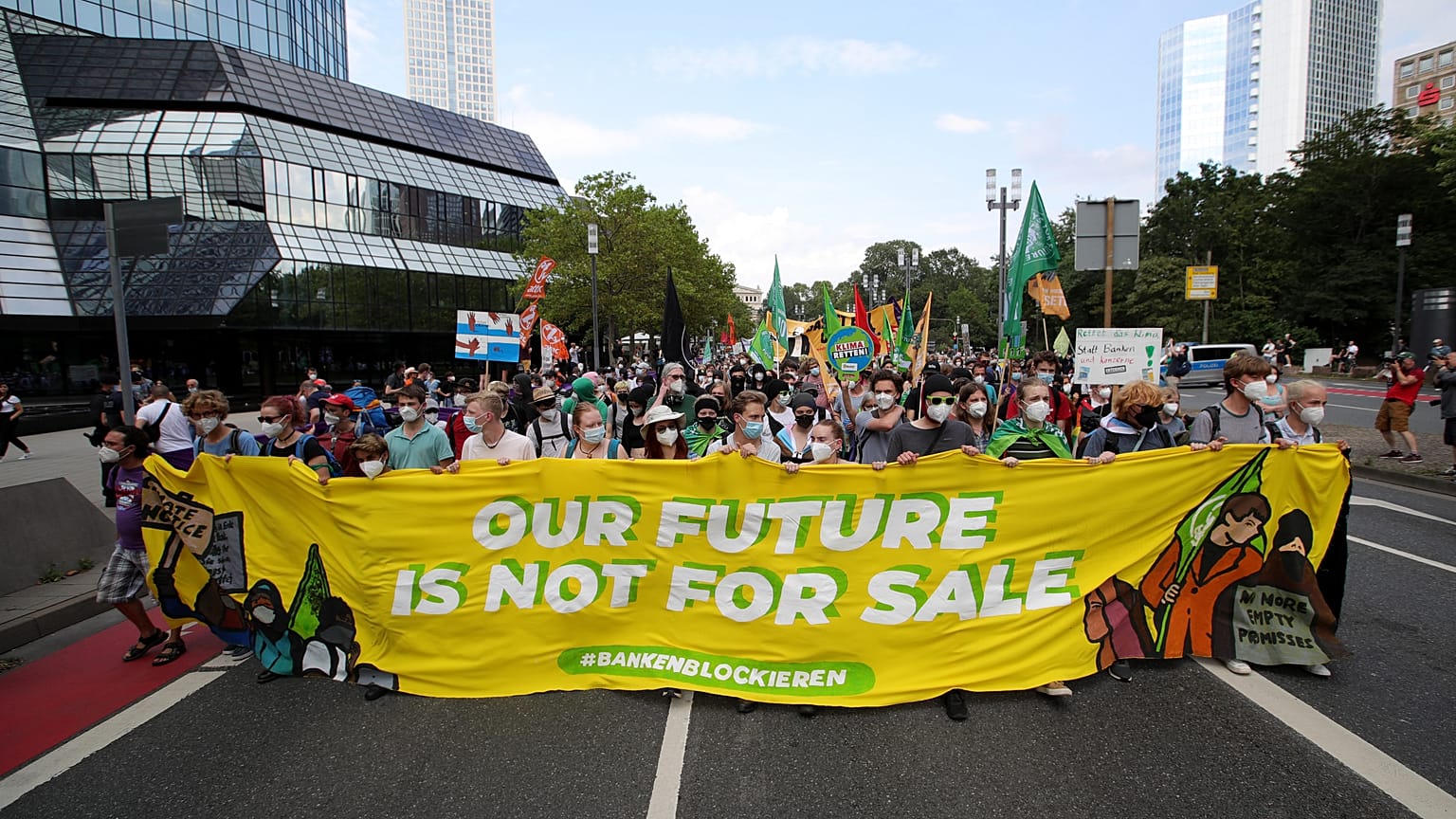 Demonstrators march in front of the Deutsche Bank headquarters during a demonstration in Frankfurt.